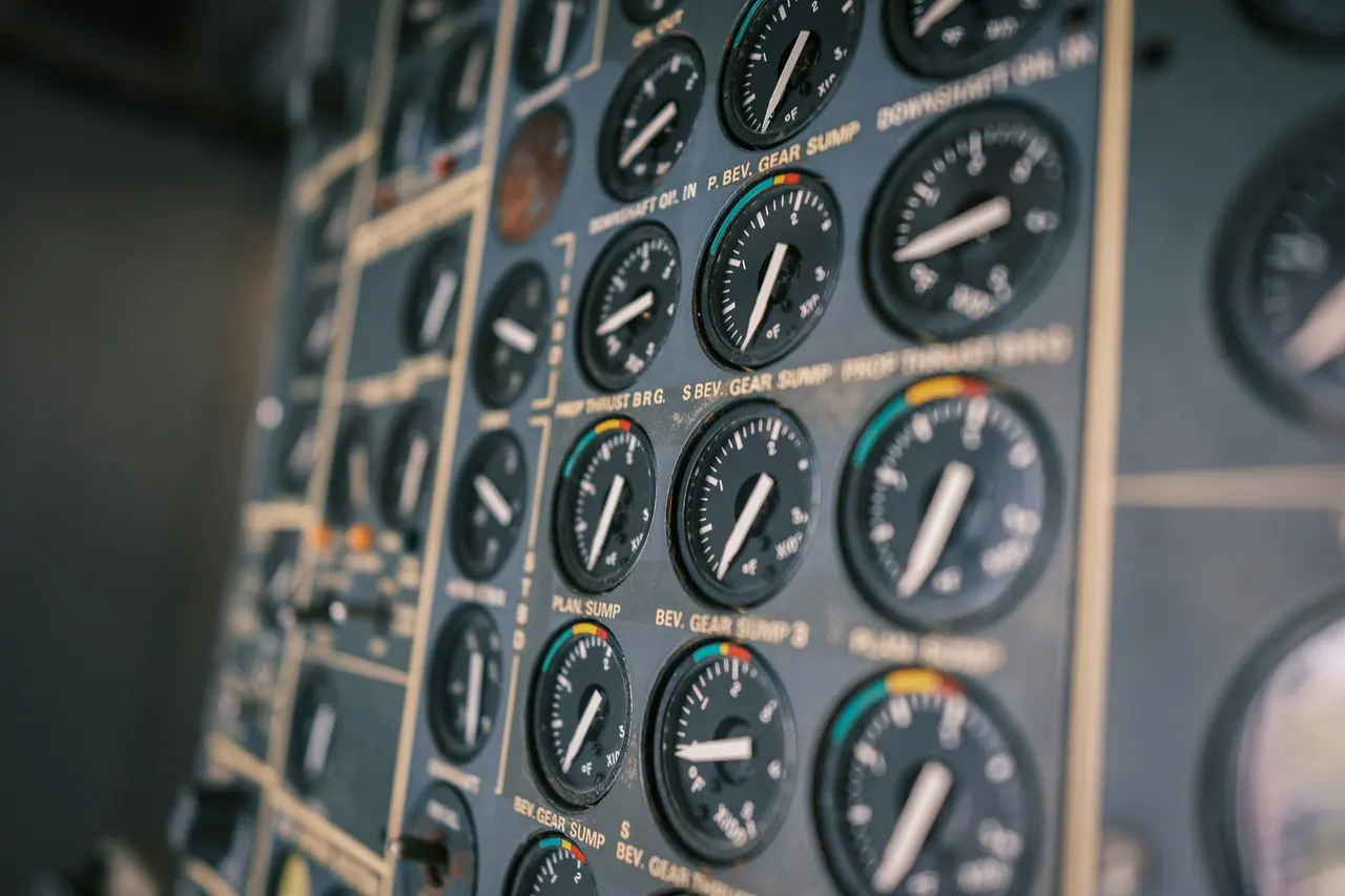 Close-up of round analogue gauges on an aircraft instrument panel